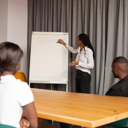 Diverse team in a business meeting with presentation on flip chart.